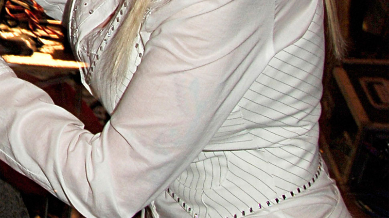 Illustration for article titled Dolly Parton's Boobs and Arms Are Covered in Secret Tattoos